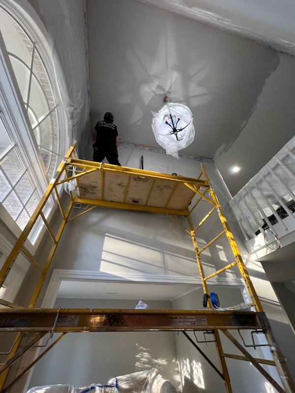 High ceiling drywall and painting on scaffolding